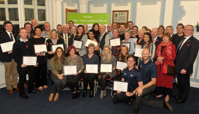 Group of people holding certificates.