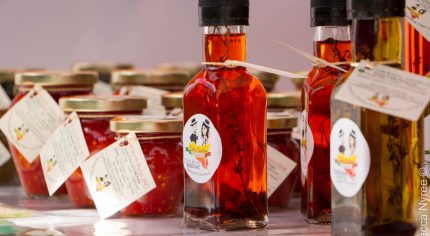 Bottles of chilli oil and jars of chilli sauce.