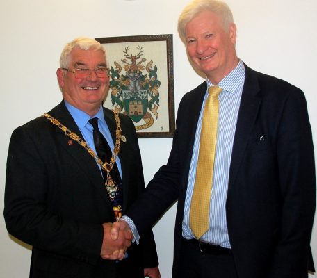 Mayor shakes hands with man in suit