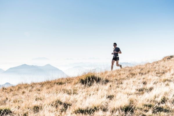 Man running. Mountains in background