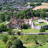 aerial photo of a castle and surrounding trees and town centre.