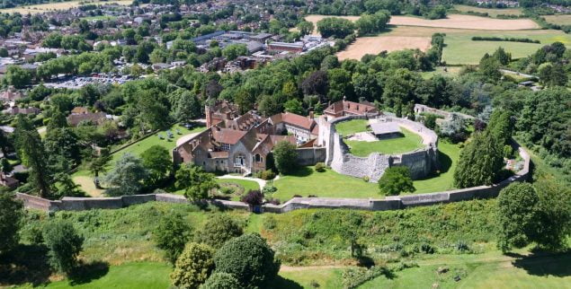 aerial photo of a castle and surrounding trees and town centre.