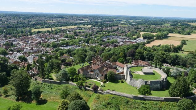 Aerial photo showing castle and green spaces and trees.