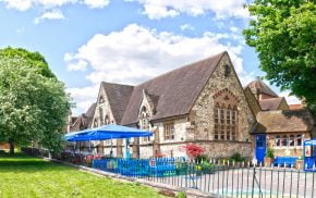 Outside of a stone school and playground.