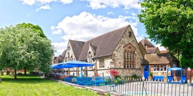 Outside of a stone school and playground.