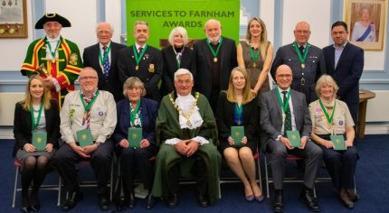 Mayor centre with group of people wearing medals