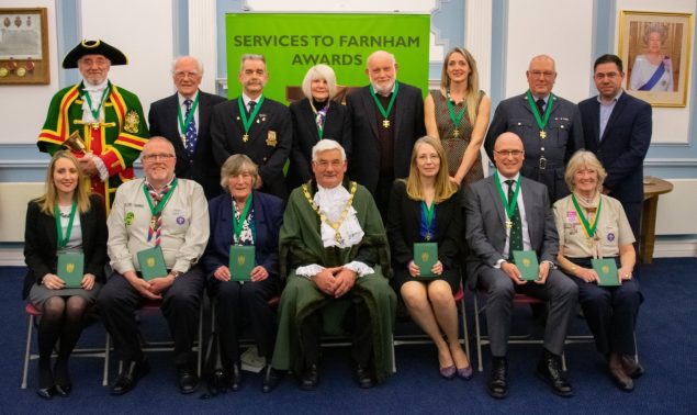 Mayor centre with group of people wearing medals