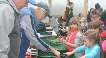 Adults and children gardening