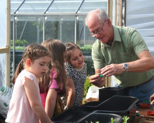 Man and children gardening.