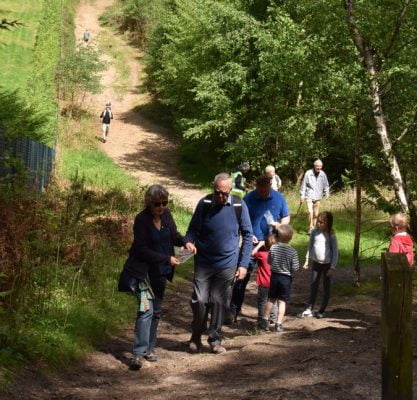 Family walking through woods.