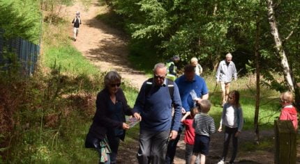 Family walking through woods.