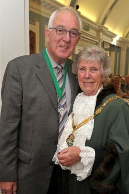 Man in suit stands next to female Mayor in robes.