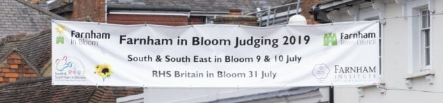 Cross street banner announcing the dates of Farnham in Bloom judging.