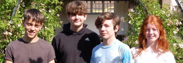 Four young people in a garden.