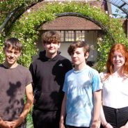 Four young people in a garden.