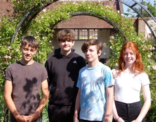 Four young people in a garden.
