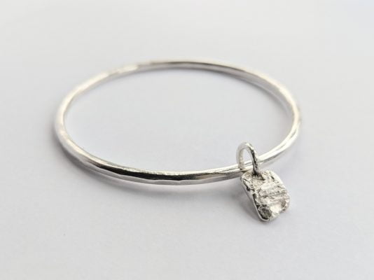 Silver bracelet and charm