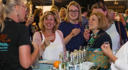 Four females sampling gin