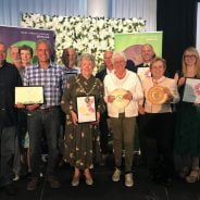 Group of people holding certificates and trophies