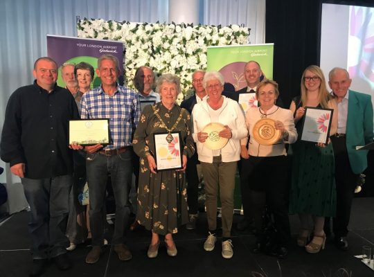 Group of people holding certificates and trophies