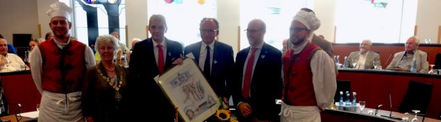 Mayor and five males. One is holding a painting