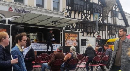 People watching a demonstration at a food festival