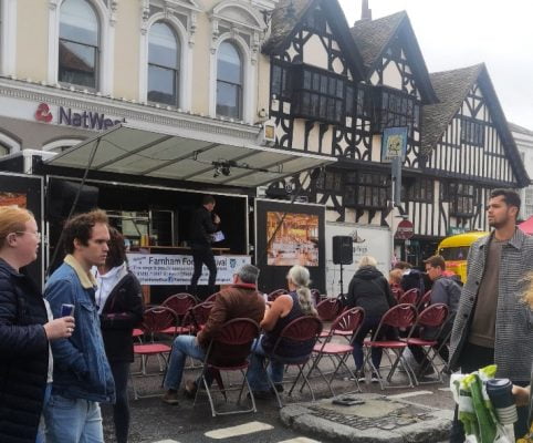 People watching a demonstration at a food festival