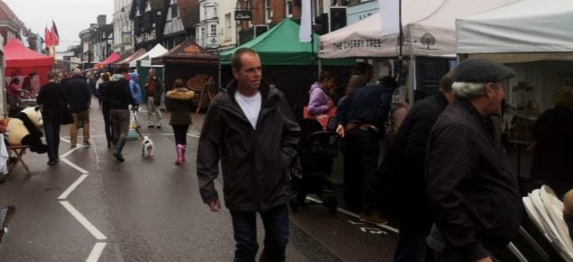 Man walking through street market.