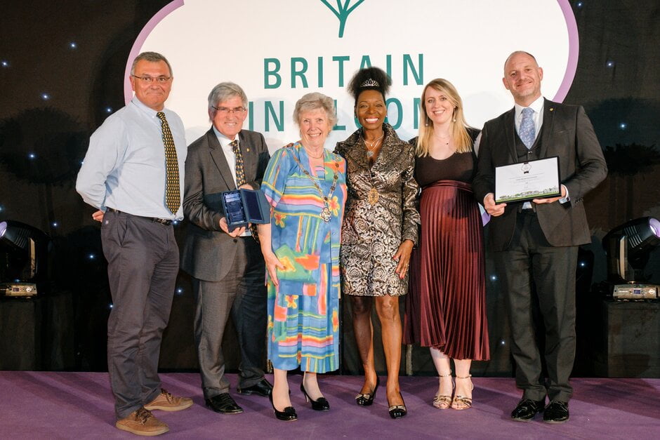 Row of six people holding awards.