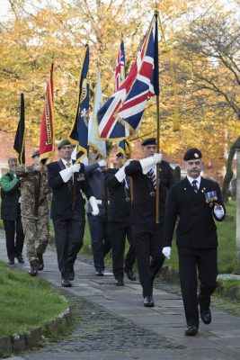 Men marching carrying standards