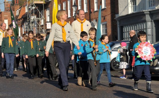 Scouts and leaders parade in street