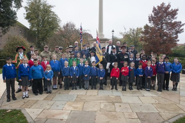 Group of school children in front of war memorial