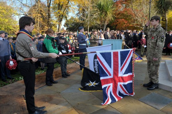 Young people in uniform lower flags