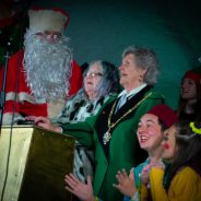 Father Christmas, two females and pantomime characters