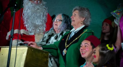 Father Christmas, two females and pantomime characters