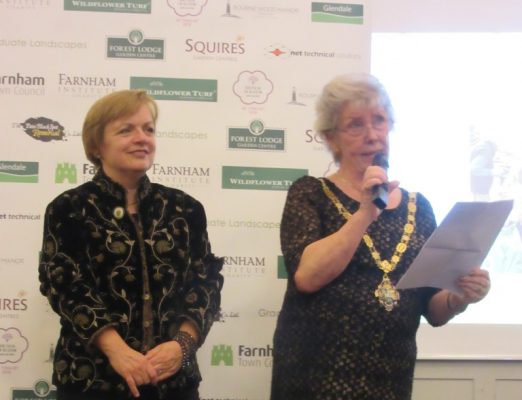 Two females. One making a speech.
