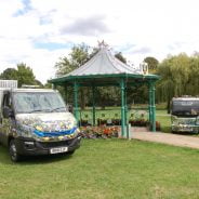 Electric vehicles parked either side of a bandstand