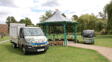 Electric vehicles parked either side of a bandstand