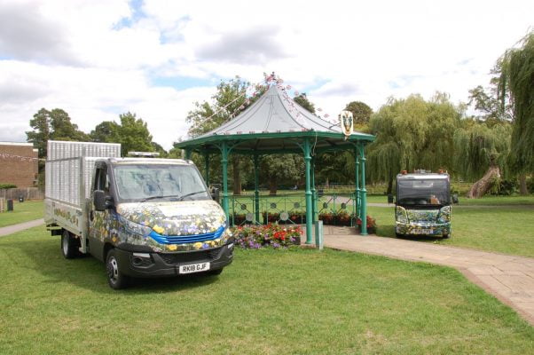 Electric vehicles parked either side of a bandstand