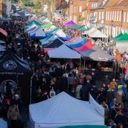 Aerial view of crowded street market and colourful marquees