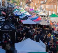 Aerial view of crowded street market and colourful marquees