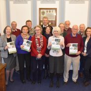 Group of people holding copies of the Farnham Neighbourhood Plan