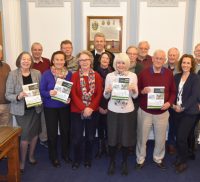 Group of people holding copies of the Farnham Neighbourhood Plan