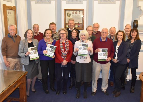 Group of people holding copies of the Farnham Neighbourhood Plan