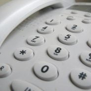 Close up showing push buttons on a white telephone