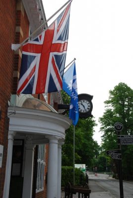 union flag flying from the front of a red brick building