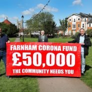 Three men holding banner advertising fundraising appeal