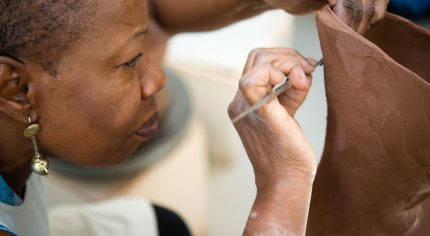 Close up of female working with clay