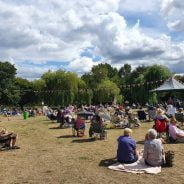 People sitting on blankets in a park