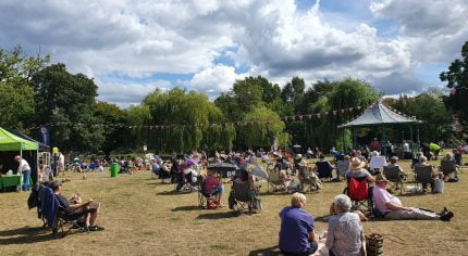 People sitting on blankets in a park